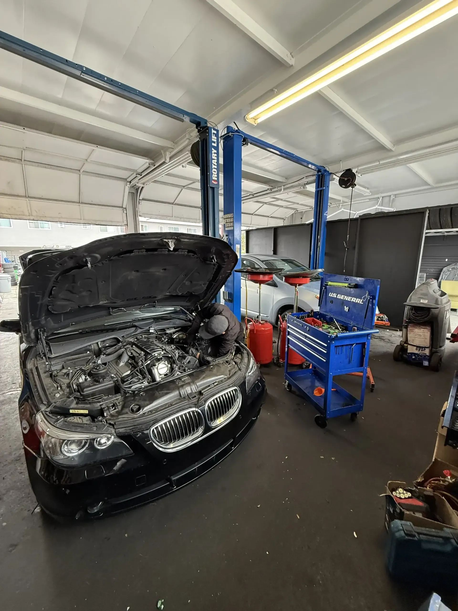 BMW 5-series on rotary lift at Beacon Auto Care San Mateo
