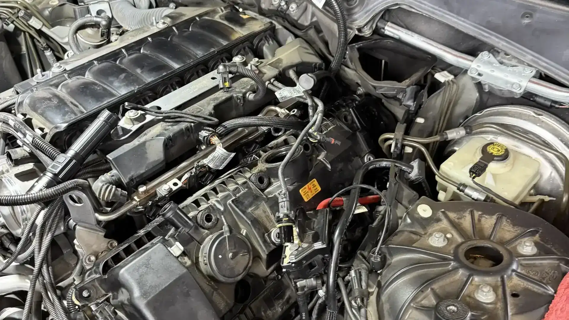 BMW inline-6 engine bay overview at Beacon Auto Care San Mateo — cooling system inspection access