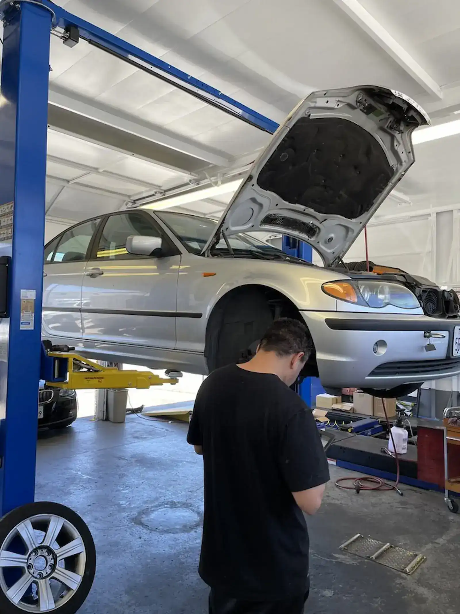 Favio, lead mechanic at Beacon Auto Care San Mateo, performing brake repair on a BMW