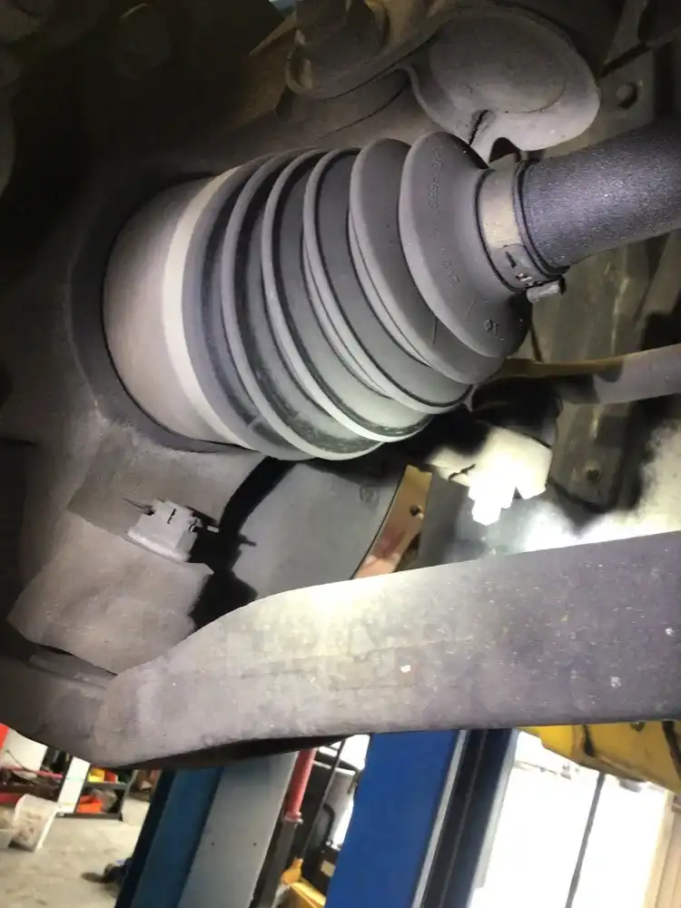 Torn CV axle boot found during noise diagnosis at Beacon Auto Care San Mateo