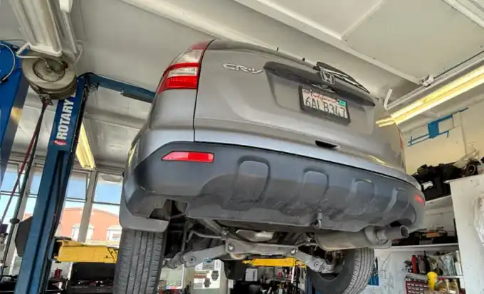 A Honda CR-V up on the rotary lift for inspection at Beacon Auto Care San Mateo