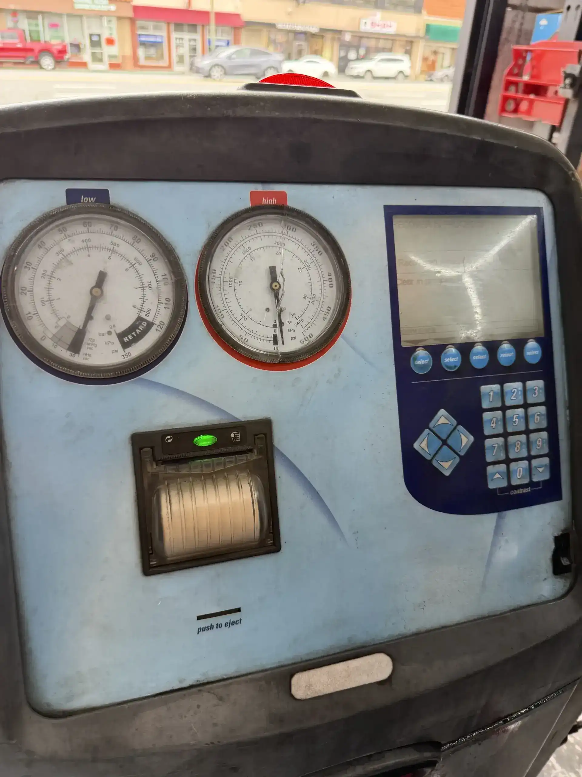 Robinair AC recharge machine panel with gauges and digital display at Beacon Auto Care San Mateo