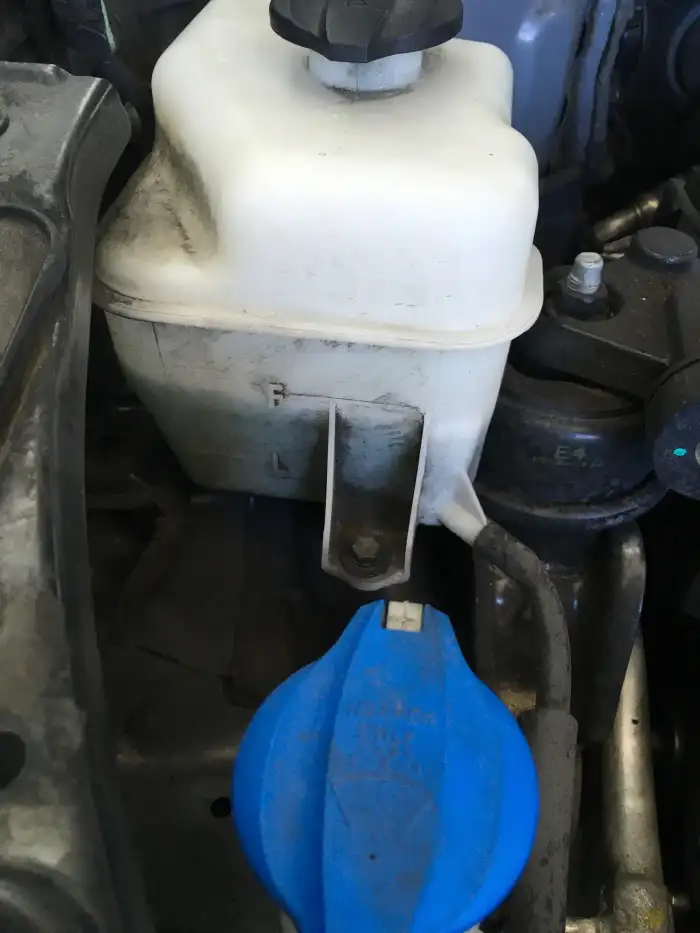 Coolant reservoir check on a 2013 Hyundai Sonata during a digital vehicle inspection in San Mateo