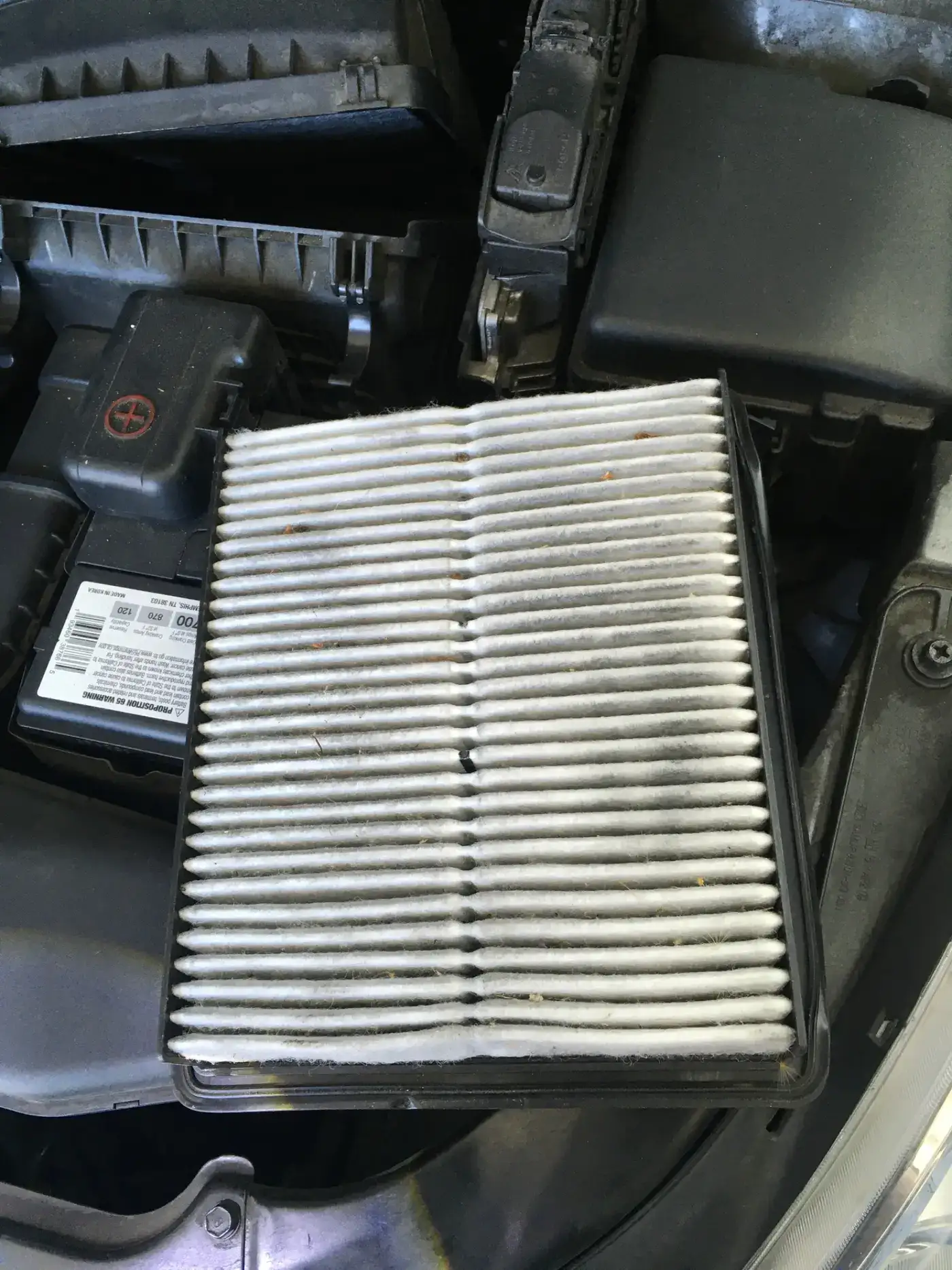 Very dirty engine air filter full of debris, photographed during a real Beacon Auto Care digital inspection in San Mateo