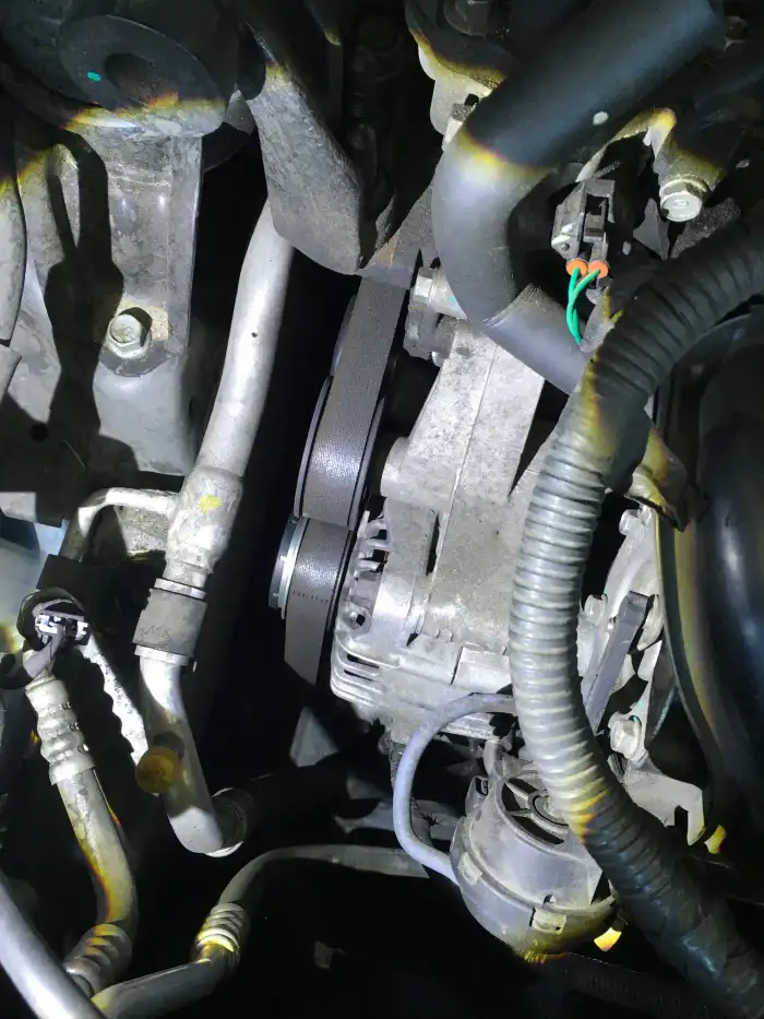 Accessory drive belt and alternator of a 2013 Hyundai Sonata during a digital vehicle inspection in San Mateo