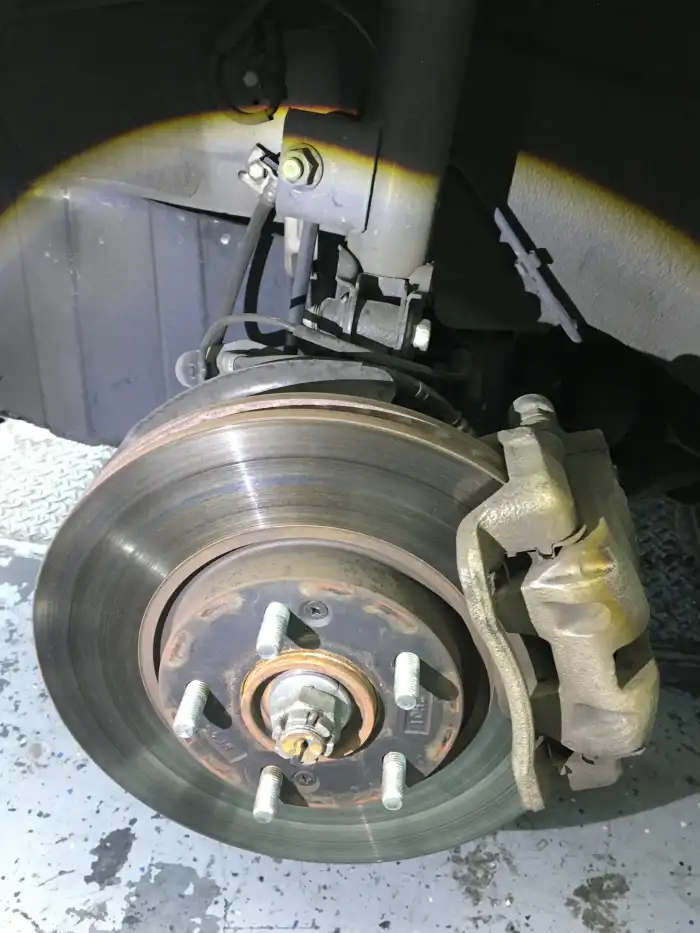 Worn and grooved front brake rotor on a 2013 Hyundai Sonata photographed during a San Mateo digital vehicle inspection