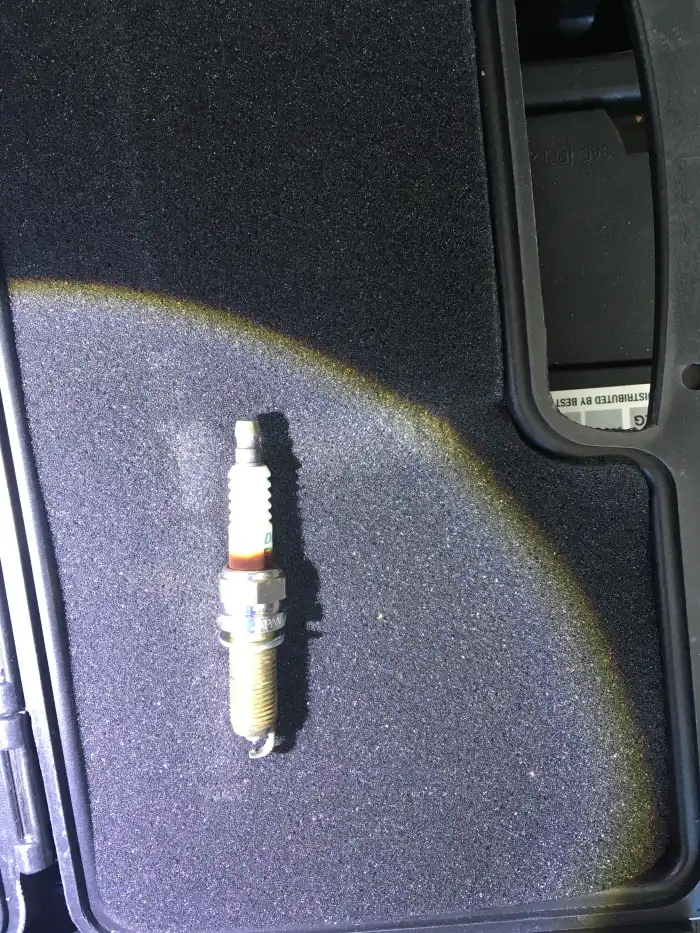 Worn spark plug removed from a 2013 Hyundai Sonata during a San Mateo inspection — tune-up was due by the maintenance schedule
