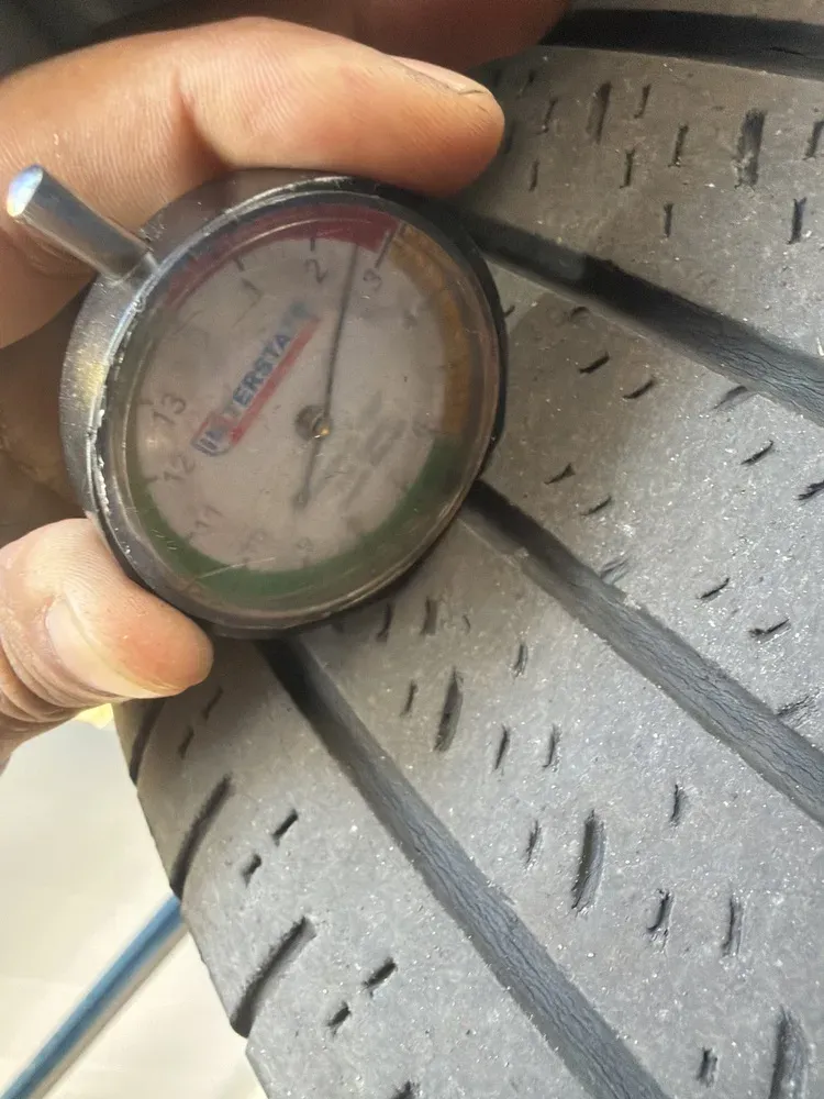 Tread depth gauge measuring tire condition during digital vehicle inspection at Beacon Auto Care San Mateo