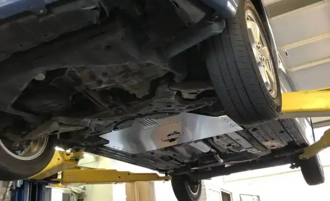 Catalytic-converter anti-theft shield installed on a Toyota Prius at Beacon Auto Care San Mateo