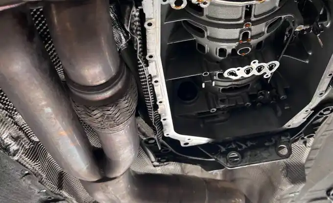 Transmission pan removed from underneath a vehicle on the lift at Beacon Auto Care San Mateo