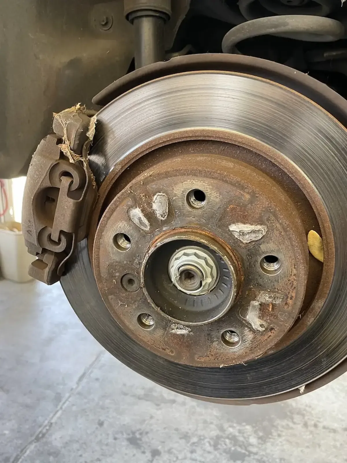 Worn brake rotor and caliper inspection